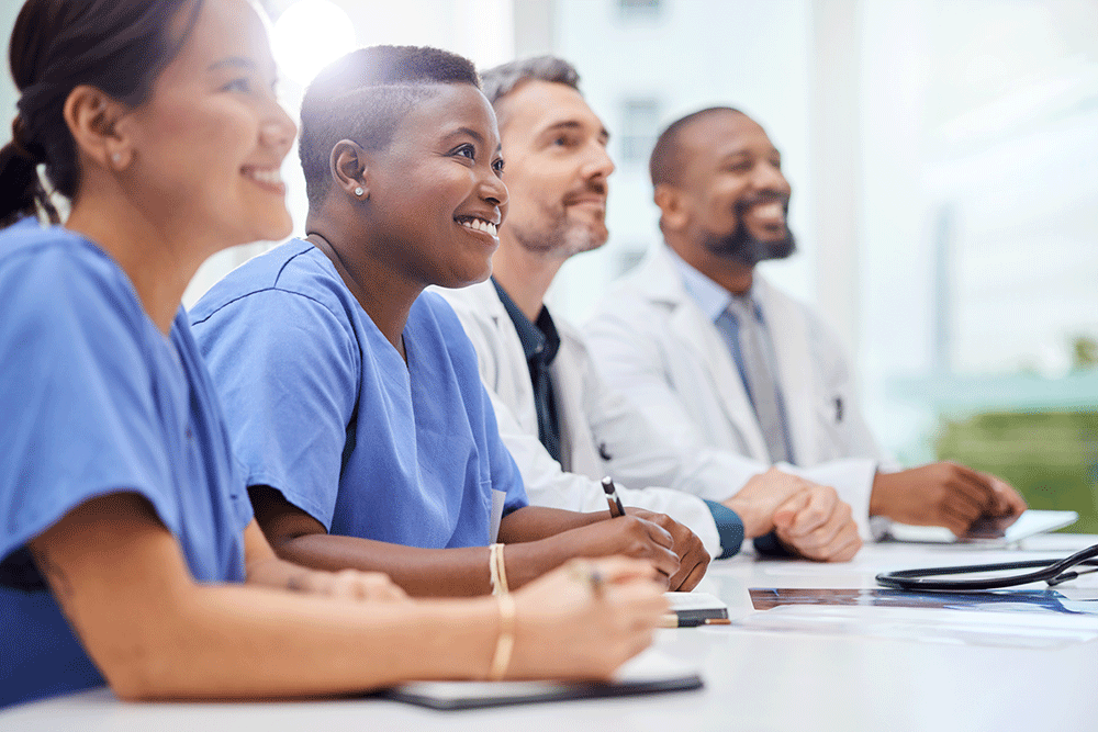 Group of doctors listening to speaker