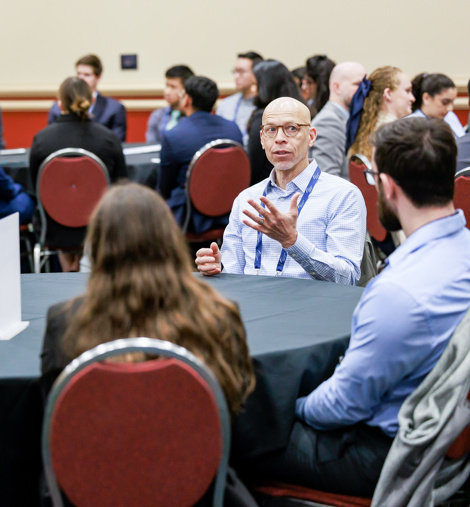 Group of SIR volunteers talking at Annual Scientific Meeting